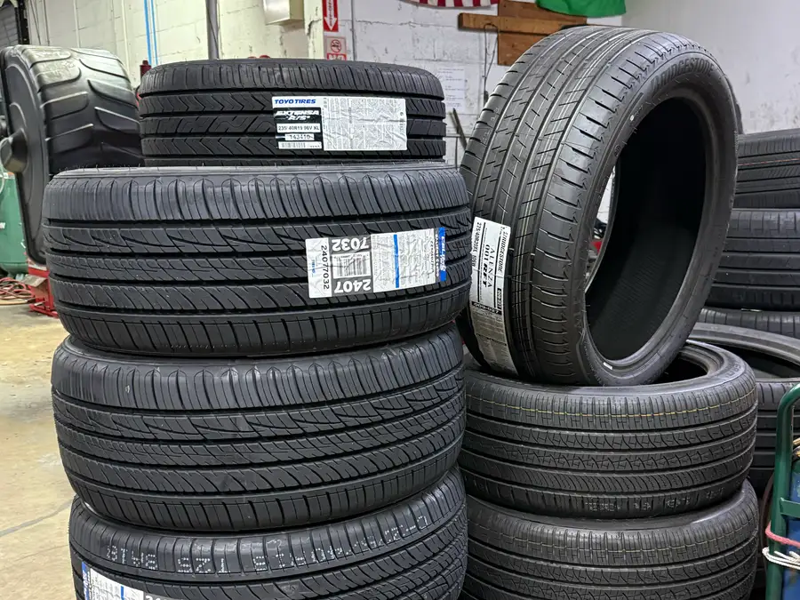 New tires stacked and ready to fit at The Tire Place USA in Deerfield Beach
