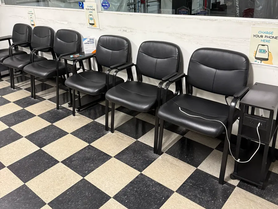 The customer waiting area at The Tire Place USA, with phone charging stations
