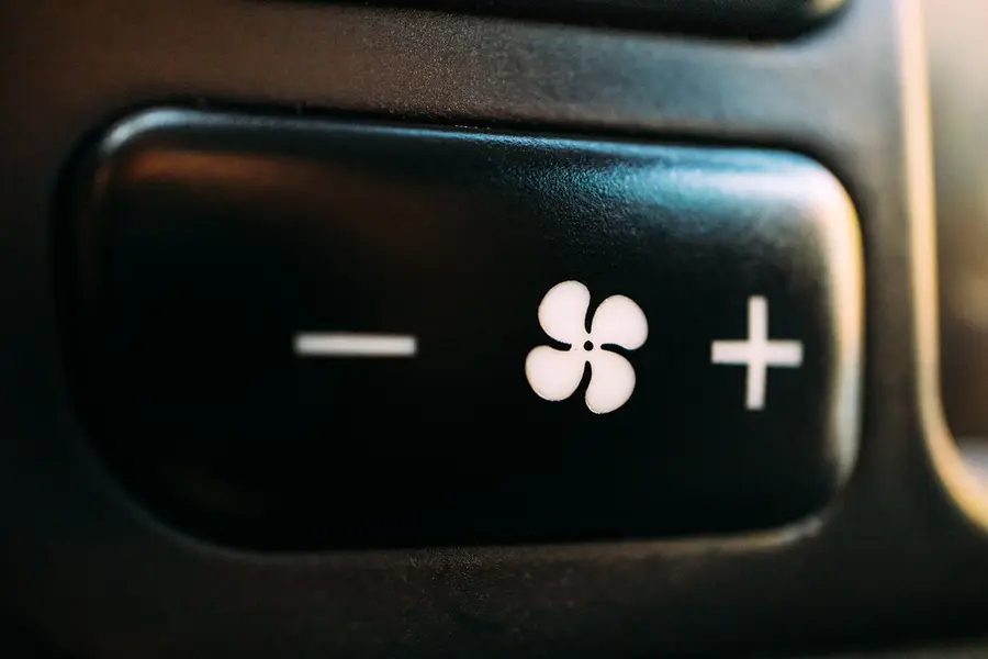 A car's air conditioning fan control button
