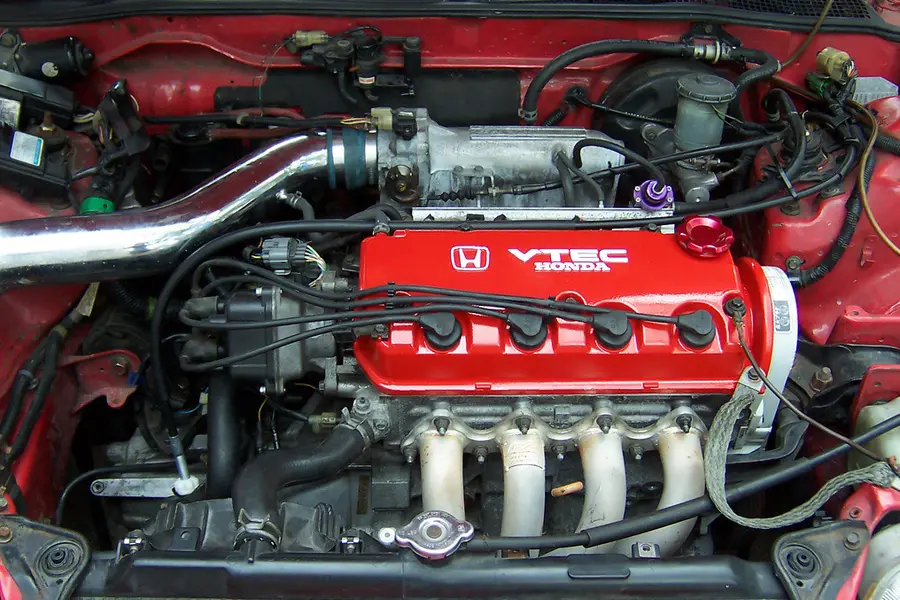 A four-cylinder engine under an open hood