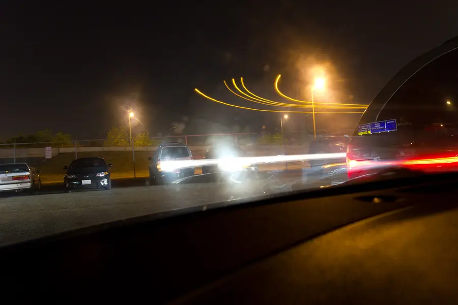 A road at night seen through a car windshield